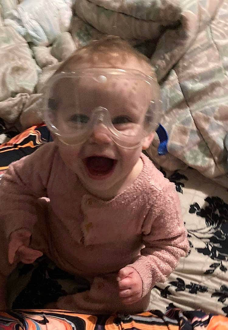 Emma joined the competition — help win amazing prizes! baby, cake, cheek, child, chin, event, facial_expression, fun, happy, head, human, laugh, linens, mouth, person, sitting, skin, smile, t_shirt, toddler