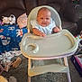 baby, blanket, carpet, child, clothing, couch, floor, footwear, furniture, happy, high_chair, home, indoors, living_room, person, pillow, plush_toy, seat, smile, toy