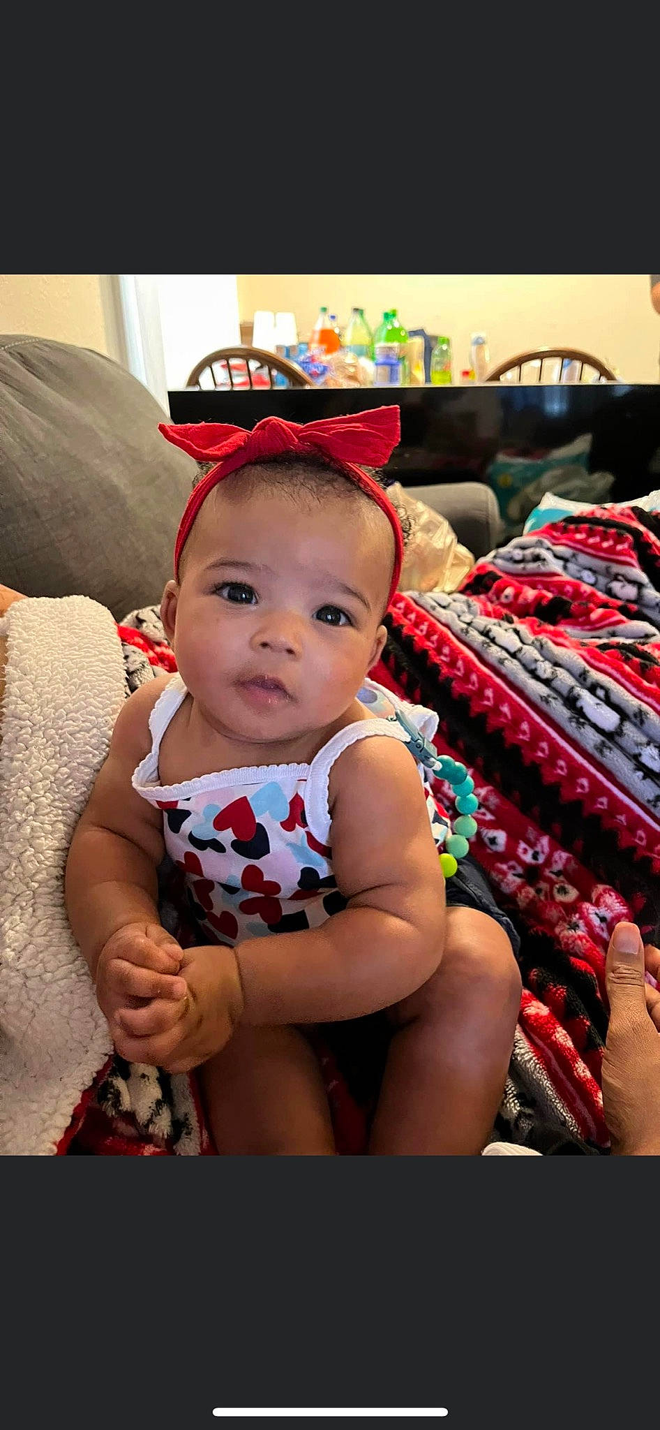 Tanyla is registered to the contest to win money with this photo: baby, baby_toddler_clothing, child, costume_hat, event, face, fashion_accessory, fun, happy, human_leg, lap, pattern, person, room, sitting, skin, smile, textile, thigh, toddler