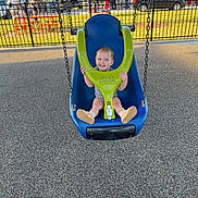 Everleigh is registered to the contest to win money with this photo: toddler, child, swing, playground, smile, outdoor, park, daylight, fence, people, grass, trees, shoes, clothing, play, fun, happy, baby, seat, chain
