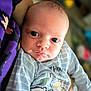 Tommy is registered to the contest to win money with this photo: baby, infant, child, person, clothing, striped, onesie, cartoon, animal, face, eyes, skin, arm, hand, holding, closeup, portrait, indoor, soft_light, cute