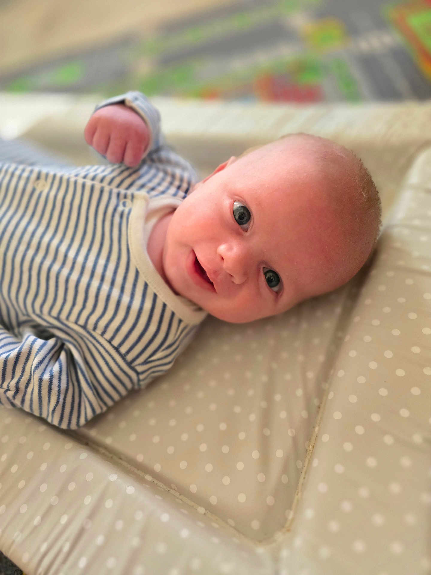 Tommy joined the competition — help win amazing prizes! baby, infant, smile, face, eyes, clothing, striped, onesie, padded_surface, polka_dot, lying_down, closeup, cute, portrait, child, young, soft_focus, indoor, baby_boy, happy