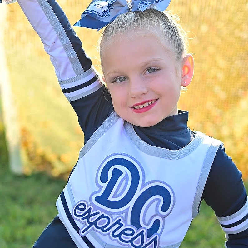 Brittany joined the competition — help win amazing prizes! blonde, cheerleading, clothing, coat, costume, face, flower, flowerarrangement, flowerbouquet, glove, grass, hair, head, jacket, people, person, photography, plant, portrait, t_shirt