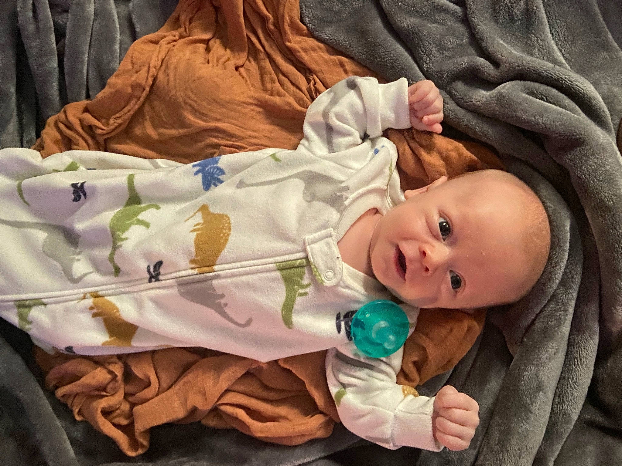 Colten is registered to the contest to win money with this photo: baby, baby_toddler_clothing, cheek, comfort, dress, eye, face, facial_expression, hand, head, human, iris, mammal, person, pink, product, skin, textile, toddler, vertebrate