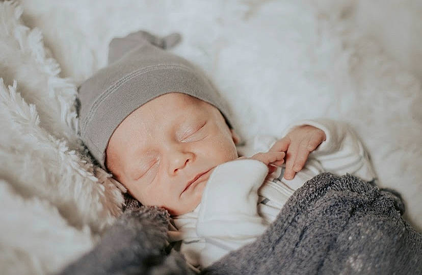 Colten joined the competition — help win amazing prizes! baby, baby_sleeping, baby_toddler_clothing, beanie, bedtime, cap, cheek, child, comfort, eyelash, fashion_accessory, fur, happy, headwear, knit_cap, linens, person, portrait_photography, skin, toddler