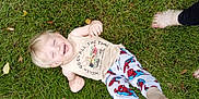 Wyatt is registered to the contest to win money with this photo: child, toddler, grass, lawn, smiling, barefoot, pajamas, tank_top, outdoor, happy, playful, person, feet, spiderman, clothing, casual, greenery, daylight, family, joy