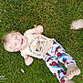 child, toddler, grass, lawn, smiling, barefoot, pajamas, tank_top, outdoor, happy, playful, person, feet, spiderman, clothing, casual, greenery, daylight, family, joy