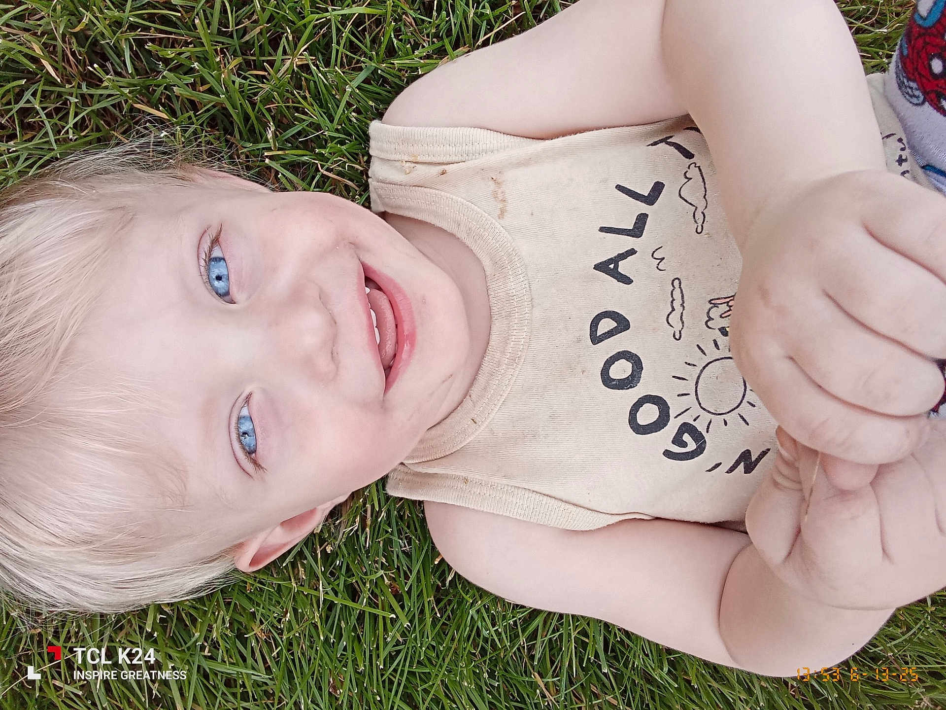 Wyatt is registered to the contest to win money with this photo: child, toddler, smiling, blue_eyes, grass, outdoor, tank_top, dirty_clothing, happy, face, hand, person, skin, blond_hair, casual, nature, summer, playing, joy, closeup