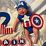 baby, infant, costume, captain_america, shield, hat, smiling, blanket, number_two, celebration, birthday, blue, red, white, letters, decorations, cute, lying_down, child, happy