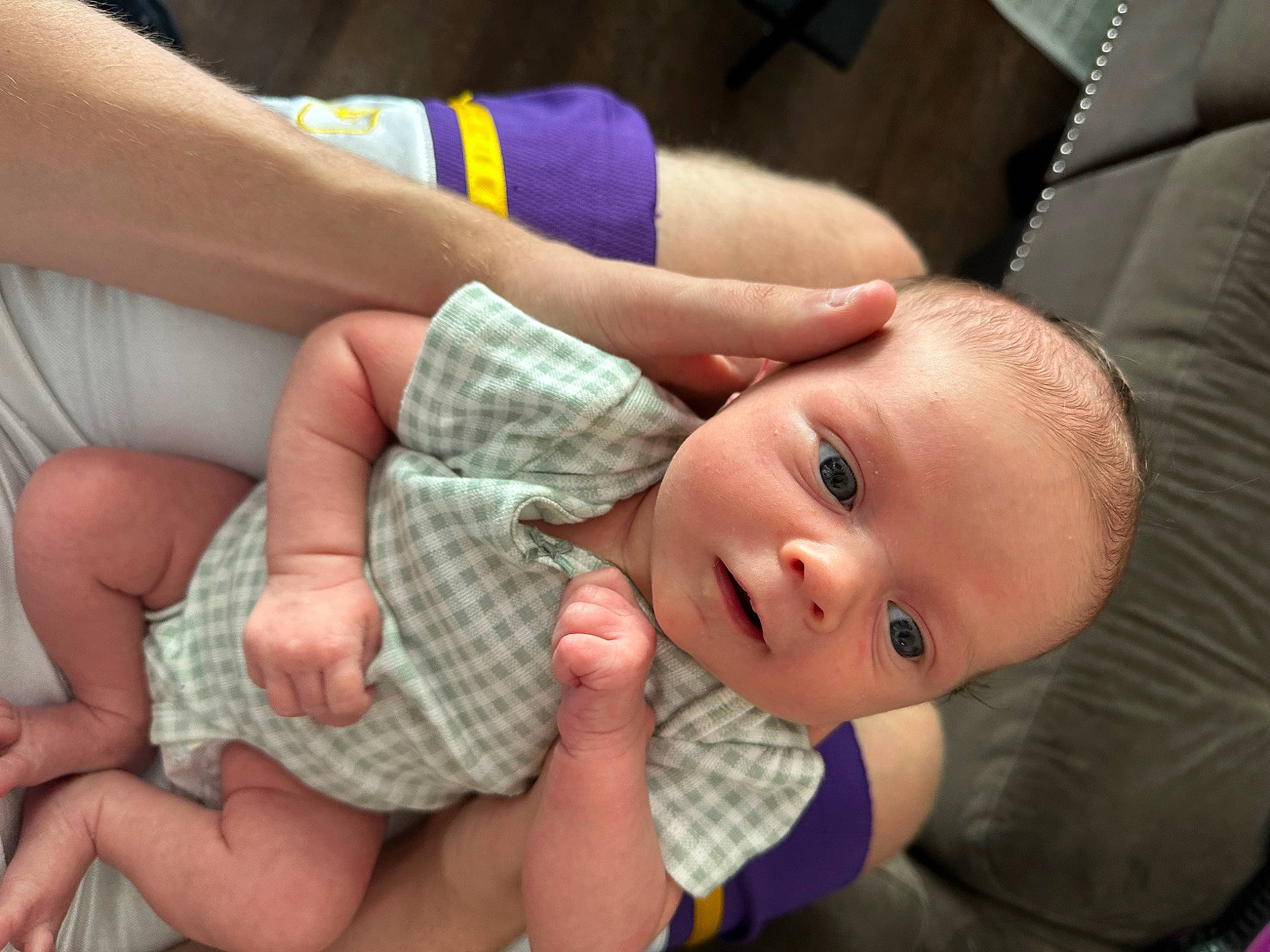 Kaia is registered to the contest to win money with this photo: baby, baby_toddler_clothing, cheek, child, comfort, couch, eye, finger, foot, gesture, hand, head, mouth, nail, nose, pattern, person, skin, thumb, toddler