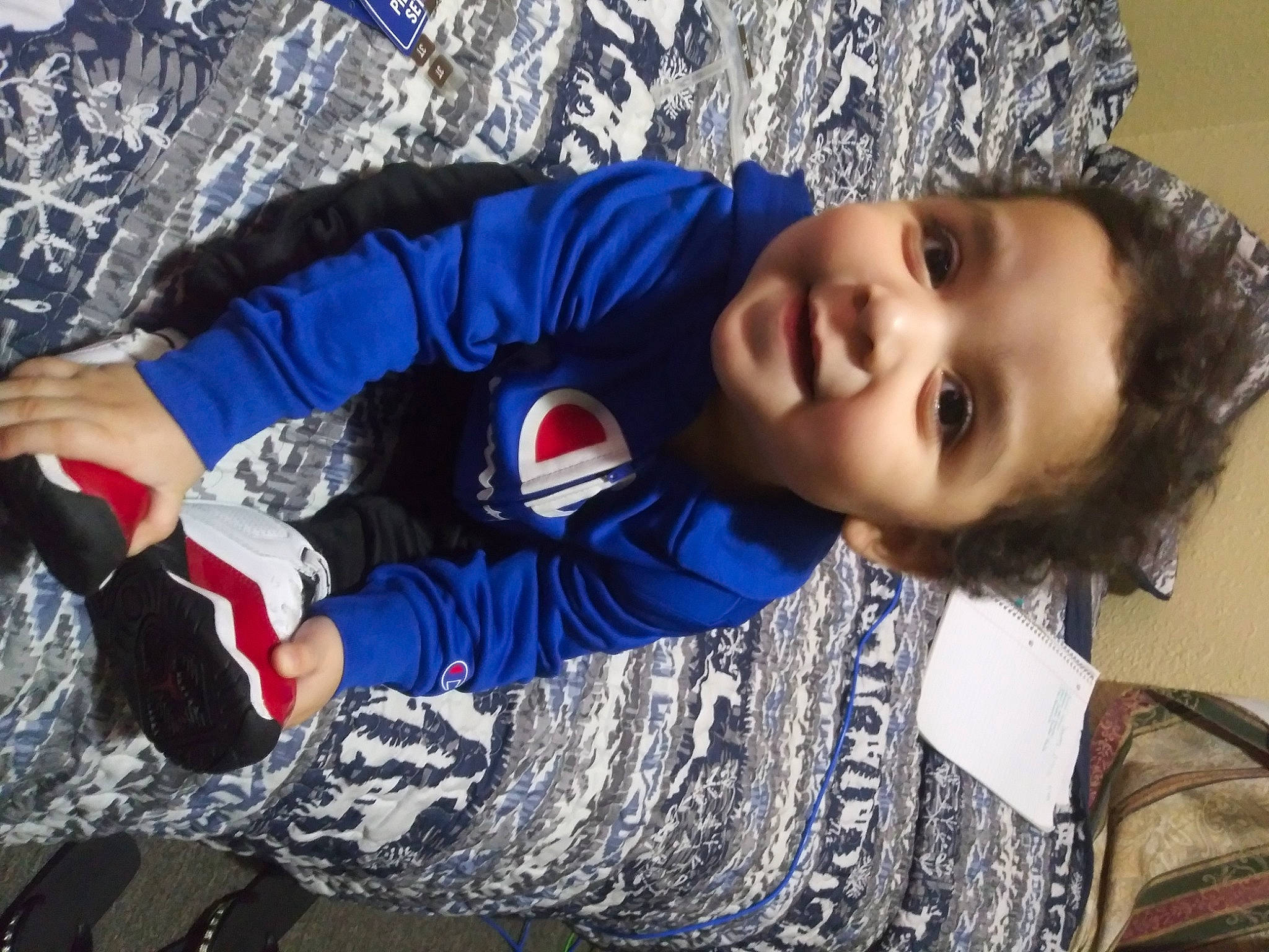 Uriel is registered to the contest to win money with this photo: child, cool, electric_blue, freezing, fun, glove, grass, happy, laugh, leisure, organ, outerwear, people_in_nature, person, play, recreation, sitting, smile, toddler, vacation