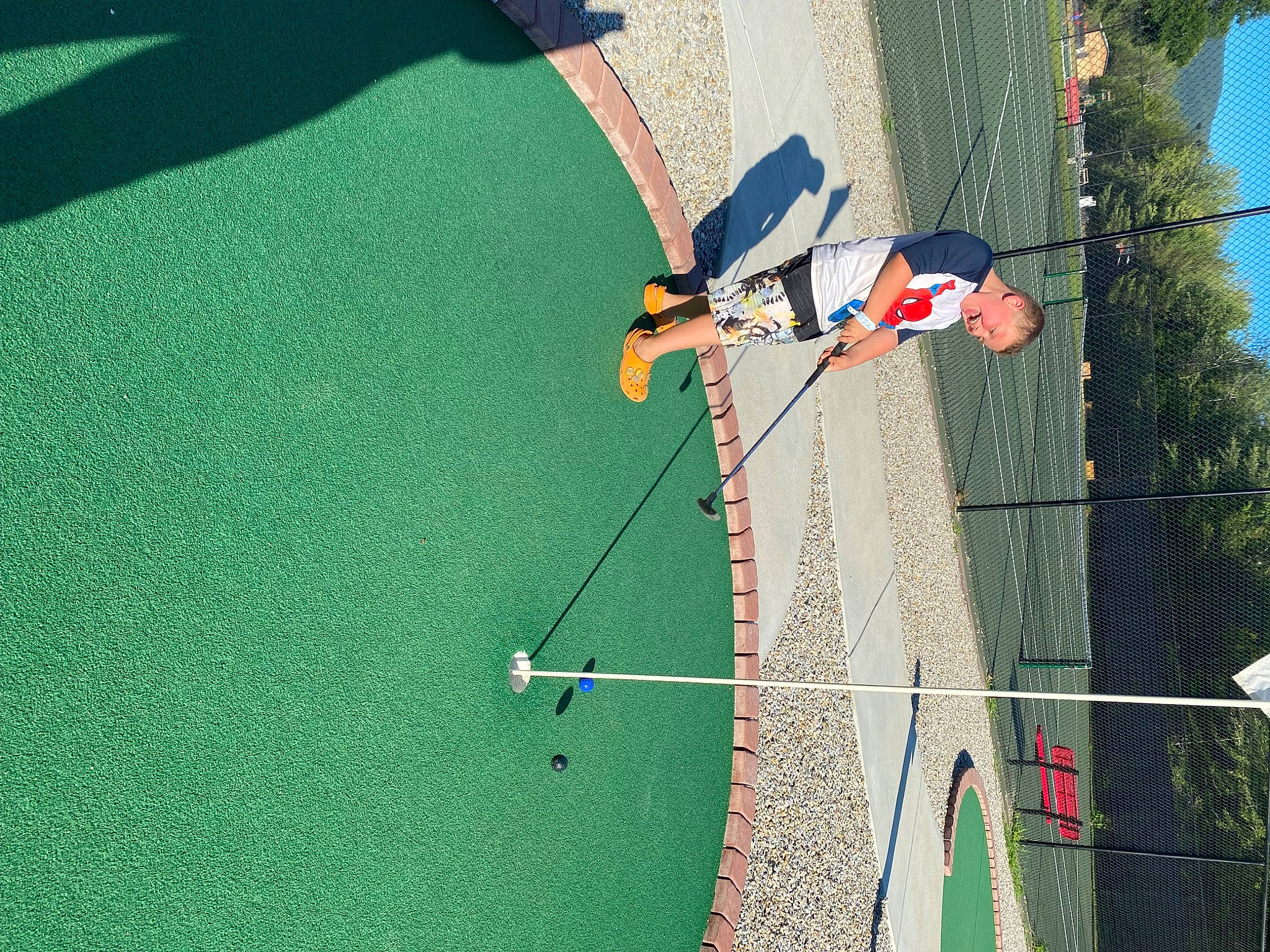 Brayden is registered to the contest to win money with this photo: adventure, air_sports, asphalt, climbing, climbing_harness, extreme_sport, fun, grass, green, leisure, net, person, plant, recreation, rock_climbing_equipment, rope, sport_climbing, sports, tree, windsports