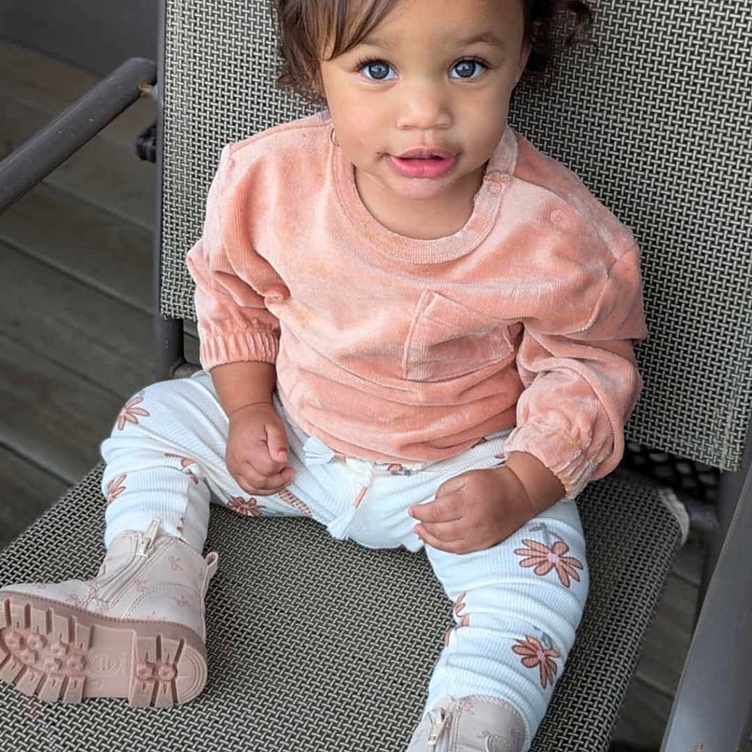 Lilliana joined the competition — help win amazing prizes! baby, blackhair, blonde, brownhair, clothing, face, footwear, hair, happy, head, jeans, pants, person, photography, portrait, sandal, shoe, sitting, sleeve, smile