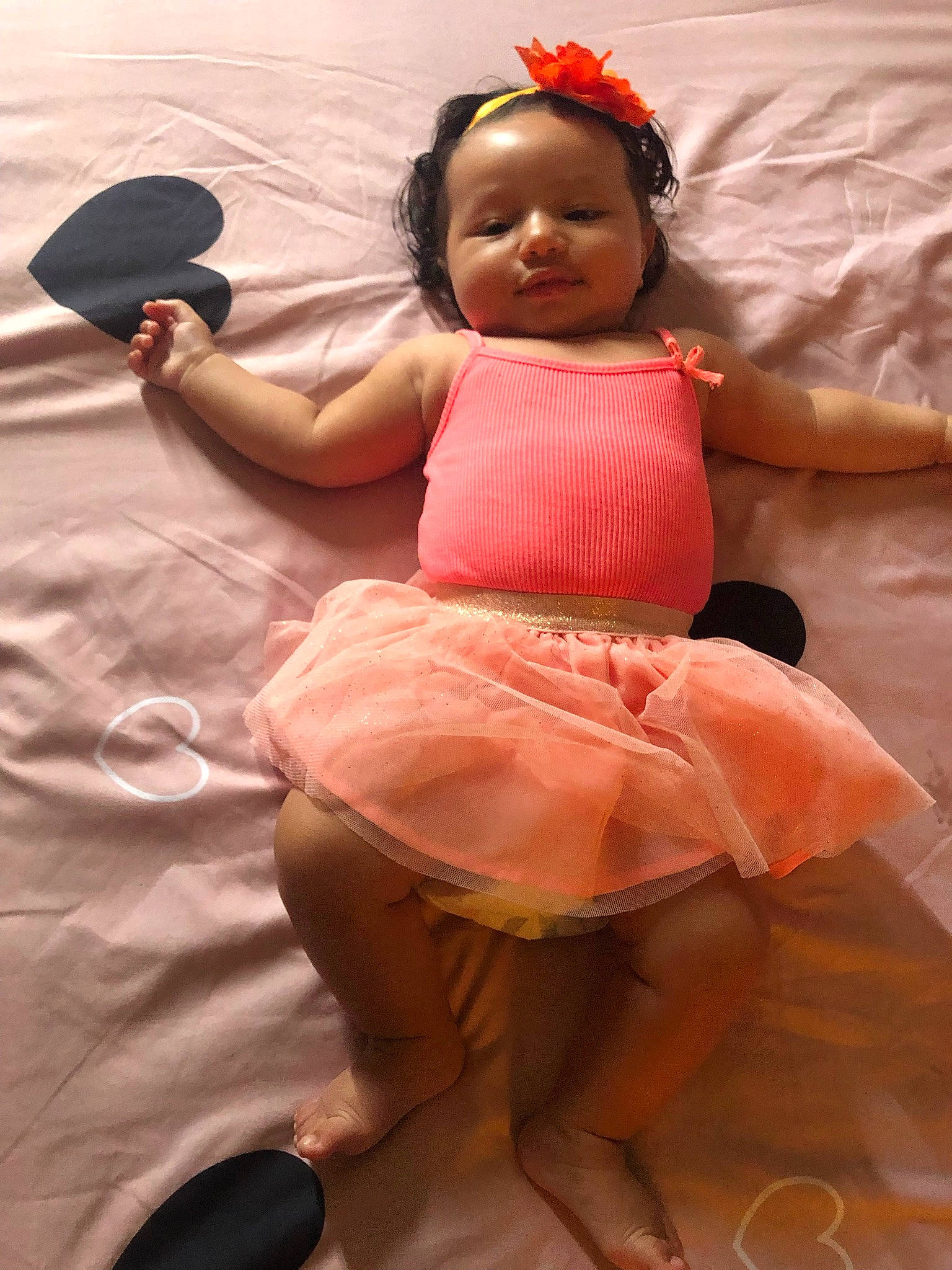 Djenna a rejoint le concours — aidez-le/la à gagner de superbes lots ! abdomen, baby_toddler_clothing, beauty, black_hair, child, dress, face, flooring, foot, fun, hand, happy, headgear, human_body, human_leg, person, pink, skin, thigh, toddler