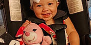 Autumn joined the competition — help win amazing prizes! baby, infant, child, car_seat, toy, plush_toy, bow_headband, smiling, happy, indoor, person, clothing, seatbelt, foot, hand, face, head, sitting, cute, playful