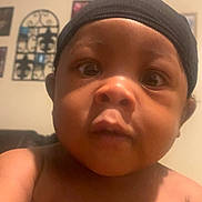 Tremayne is registered to the contest to win money with this photo: architecture, baby, baseballcap, beanie, bodypart, bonnet, building, cap, clothing, face, finger, hand, hat, head, indoors, person, photography, portrait, selfie, swimwear