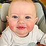 baby, infant, child, face, blue_eyes, rosy_cheeks, smile, closeup, sweater, clothing, car_seat, stroller, light_hair, eyelashes, portrait, cheek_smear, mouth, cute, sitting, peaceful