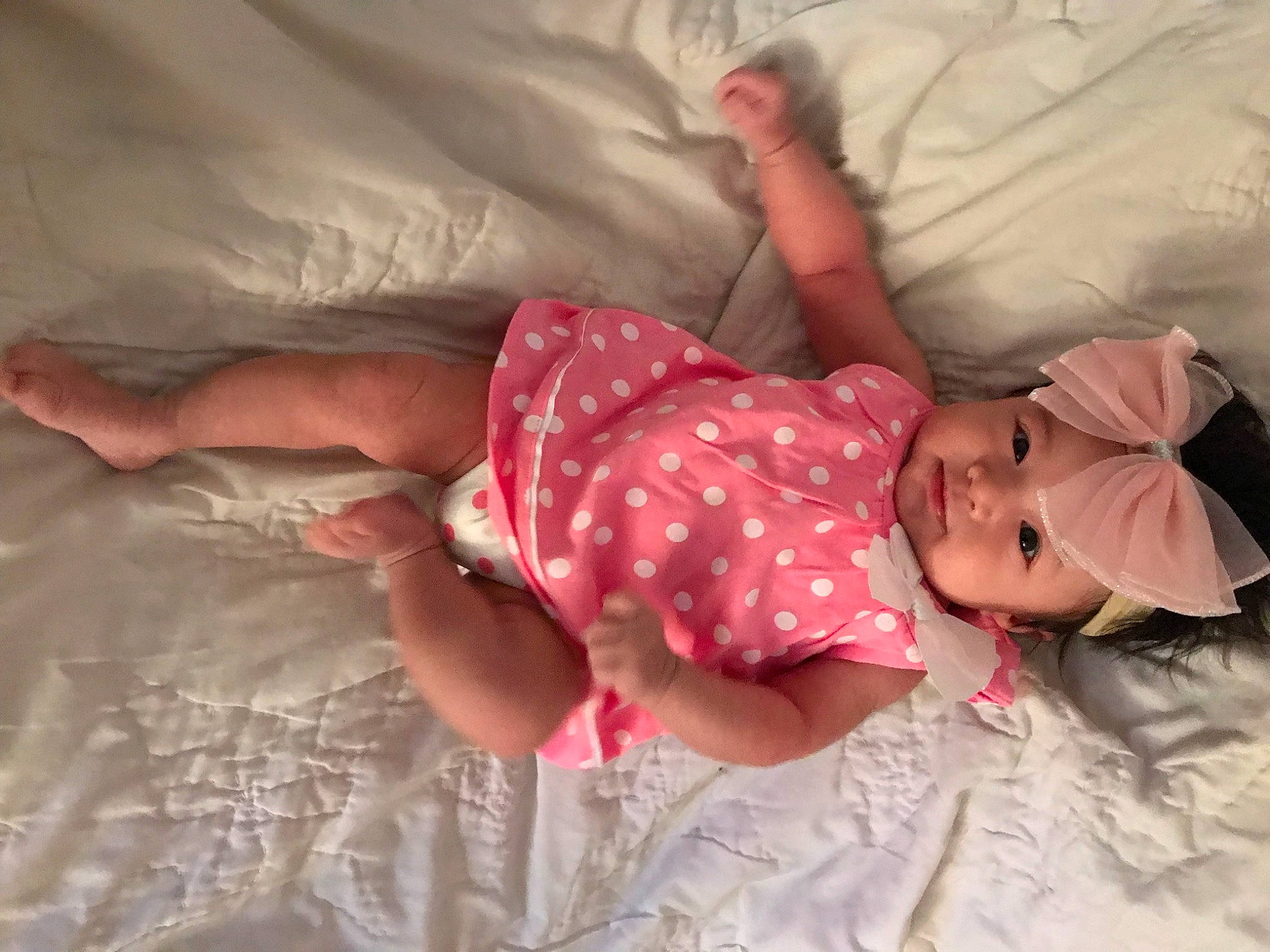 Stella is registered to the contest to win money with this photo: baby, baby_products, baby_toddler_clothing, bed, bed_sheet, bedding, bedroom, bedtime, child, comfort, finger, headwear, human_body, human_leg, linens, nap, pattern, person, pink, room