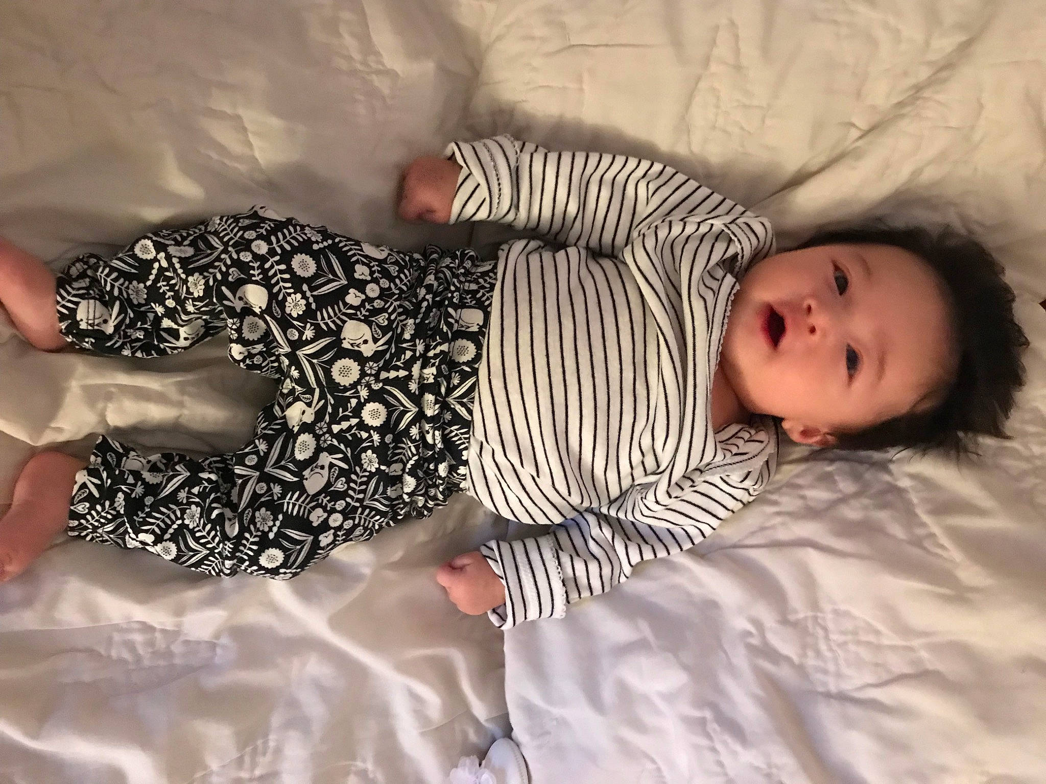Stella is registered to the contest to win money with this photo: baby, baby_toddler_clothing, child, comfort, eye, gesture, happy, human, human_leg, linens, mammal, pattern, person, room, sleeve, thigh, toddler, vertebrate, waist, wood
