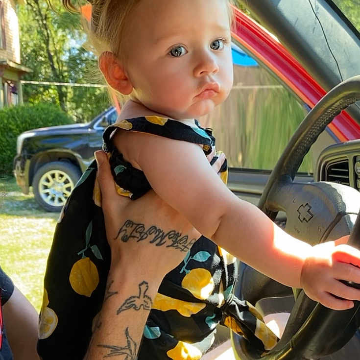 Lorelei joined the competition — help win amazing prizes! alloywheel, baby, car, carwheel, clothing, face, head, machine, outdoors, person, photography, portrait, shorts, skin, spoke, tattoo, tire, transportation, vehicle, wheel