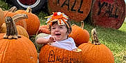 Nadia joined the competition — help win amazing prizes! baby, pumpkin, child, tractor, hay_bale, grass, outdoor, fall, smile, hat, sitting, festive, autumn, happy, nature, farm, orange, blue_sky, costume, celebration