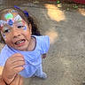 Maya joined the competition — help win amazing prizes! child, face_paint, holding_hand, outdoor, smiling, purple_bow, curb, concrete, playful, person, happy, toddler, casual_clothing, calvin_klein, daylight, sidewalk, expression, closeup, young_girl, cute