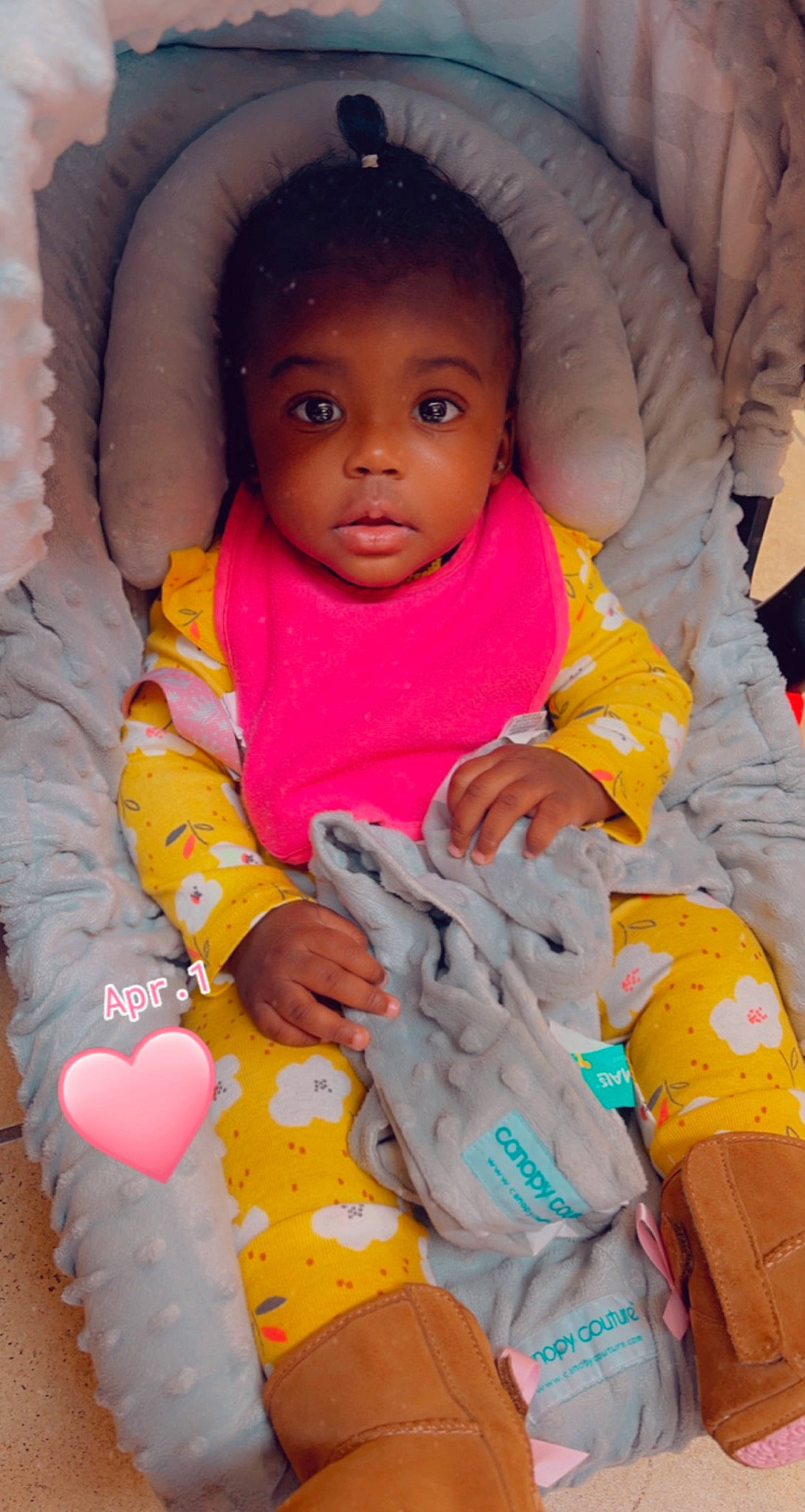 Avah is registered to the contest to win money with this photo: arm, baby_toddler_clothing, cheek, comfort, eye, facial_expression, hand, head, human_body, lip, mouth, nose, orange, outerwear, person, product, purple, skin, sleeve, textile