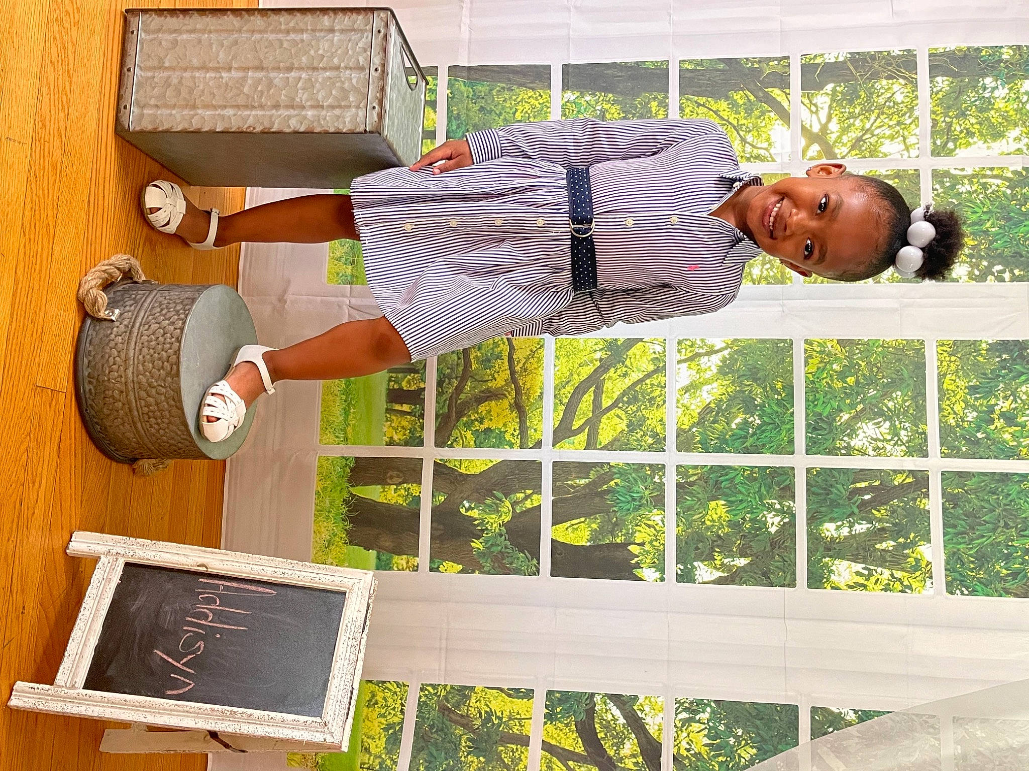 Addisyn joined the competition — help win amazing prizes! grass, hat, houseplant, joy, leisure, person, plant, room, smile, tire, tree, wheel, wood, yellow