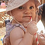 arm, baby, beverage, cafe, child, clothing, curious, cute, face, floral_pattern, hand, hat, holding, outdoor, person, portrait, straw, summer, sunlight, table