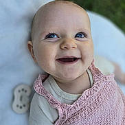 Eléanore participe au concours pour gagner de l'argent avec cette photo : baby, smiling, blue_eyes, pink_clothing, knitted, infant, happy, closeup, face, outdoor, blanket, cute, portrait, child, toddler, soft_texture, skin, person, natural_light, background_blur