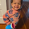 Romi joined the competition — help win amazing prizes! toddler, child, smiling, pajamas, cartoon_pattern, cup, barefoot, wooden_floor, indoors, home, happy, person, standing, curly_hair, long_sleeves, flooring, door, playful, cute, young_child