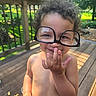 Romi joined the competition — help win amazing prizes! child, curly_hair, cute, deck, funny, glasses, greenery, hand_on_mouth, happy, nature, outdoor, oversized_glasses, person, playful, shirtless, smiling, summer, sunlight, toddler, wooden_deck