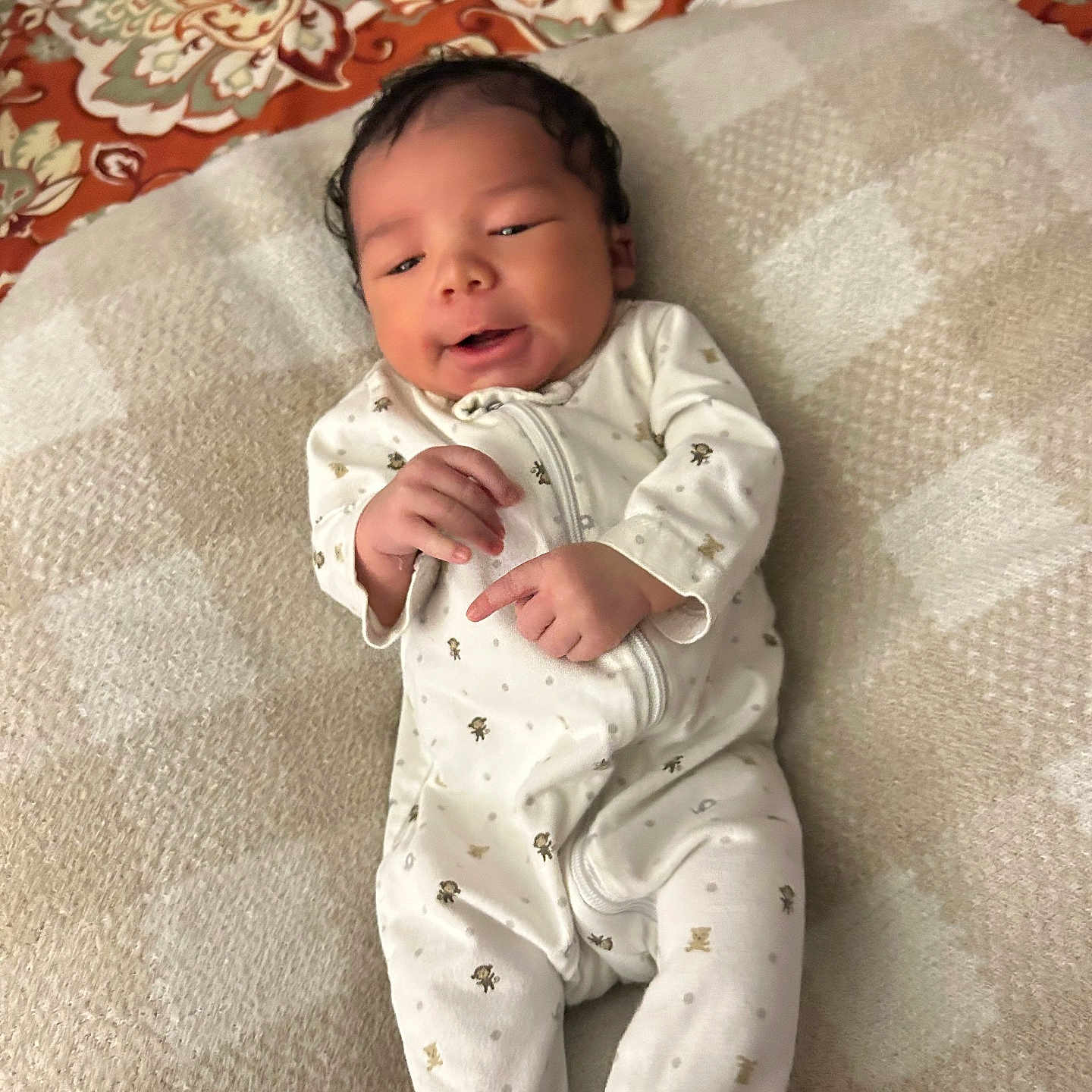 Branson joined the competition — help win amazing prizes! baby, blanket, child, cozy, cute, face, footed_pajamas, hand, happy, indoors, infant, lying_down, newborn, patterned_clothing, person, portrait, relaxed, sleepwear, smiling, soft_texture