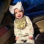 baby, child, smile, bow, hat, bib, camo, car_interior, seat, clothing, cute, portrait, happy, infant, person, night, window, light, warm_light, young_child