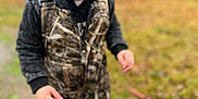 Huntley Grace joined the competition — help win amazing prizes! toddler, child, pacifier, outdoor, camouflage, hoodie, boots, grass, muddy, nature, person, young_child, clothing, autumn, portrait, curious, standing, daylight, face, cute