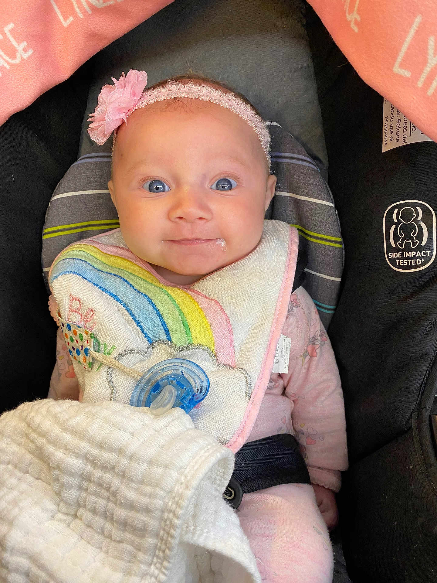 Lynzee joined the competition — help win amazing prizes! baby, infant, car_seat, headband, flower, bib, pacifier, blanket, drool, pink_clothing, child, cute, portrait, indoors, seatbelt, happy, face, blue_eyes, soft_lighting, cozy