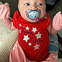 Lynzee joined the competition — help win amazing prizes! baby, infant, pacifier, red_clothing, pink_mittens, blanket, cute, face, person, indoor, child, newborn, apparel, text_on_clothing, head, skin, eyes, sitting, comfort, soft