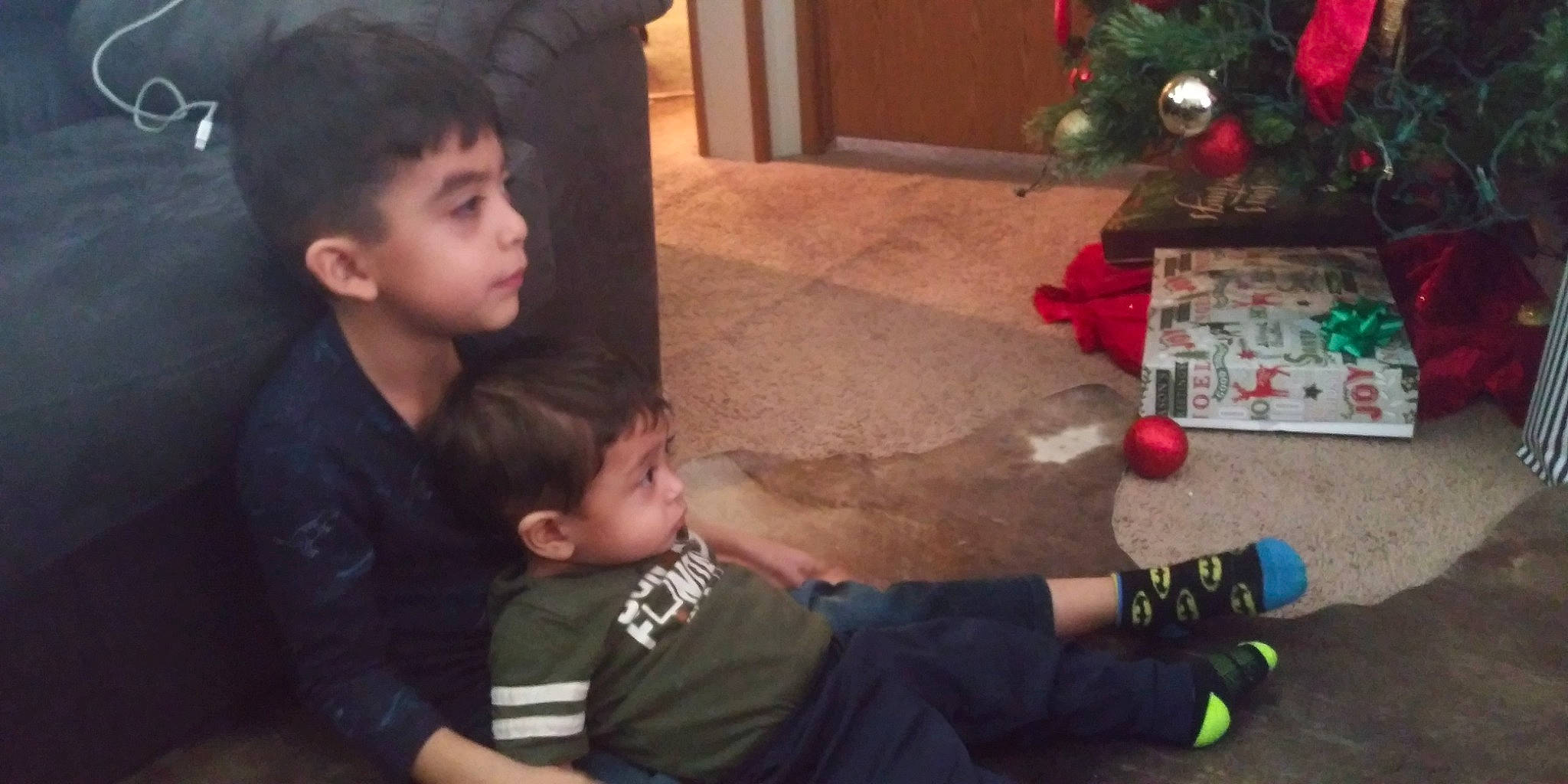 Nathan Y Carlos joined the competition — help win amazing prizes! baby_toddler_clothing, black_hair, child, christmas, christmas_decoration, christmas_eve, christmas_ornament, ear, holiday, holiday_ornament, human, interaction, interior_design, person, play, sharing, sitting, skin, snapshot, sock