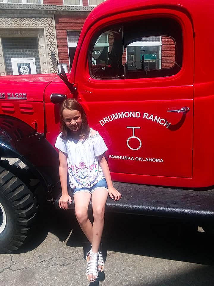 Ellen is registered to the contest to win money with this photo: automotive_tire, automotive_wheel_system, beauty, black_hair, car, classic, classic_car, custom_car, motor_vehicle, person, pink, vehicle, vehicle_door, vintage_car, wheel