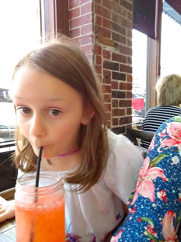 Ellen is registered to the contest to win money with this photo: child, drink, drinking, juice, lip, orange_drink, orange_juice, orange_soft_drink, person, smoothie, summer, surprise, tea, vacation