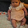 Ariyah is registered to the contest to win money with this photo: baby, infant, child, headwrap, clothing, shoes, blanket, sitting, cute, portrait, face, person, indoors, serious_expression, floral_pattern, soft_toys, skin, arm, leg, fabric