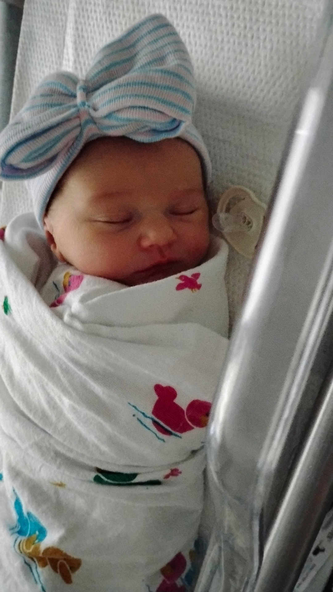 Ember joined the competition — help win amazing prizes! newborn, baby, sleeping, swaddle, hat, bow, crib, pacifier, infant, cute, resting, child, bed, blanket, soft, peaceful, indoors, closeup, wrapped, portrait