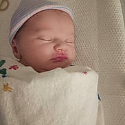 Ember joined the competition — help win amazing prizes! baby, newborn, sleeping, hat, blanket, infant, closeup, face, peaceful, wrapped, cozy, soft, cute, child, bed, resting, indoors, portrait, headwear, sleep