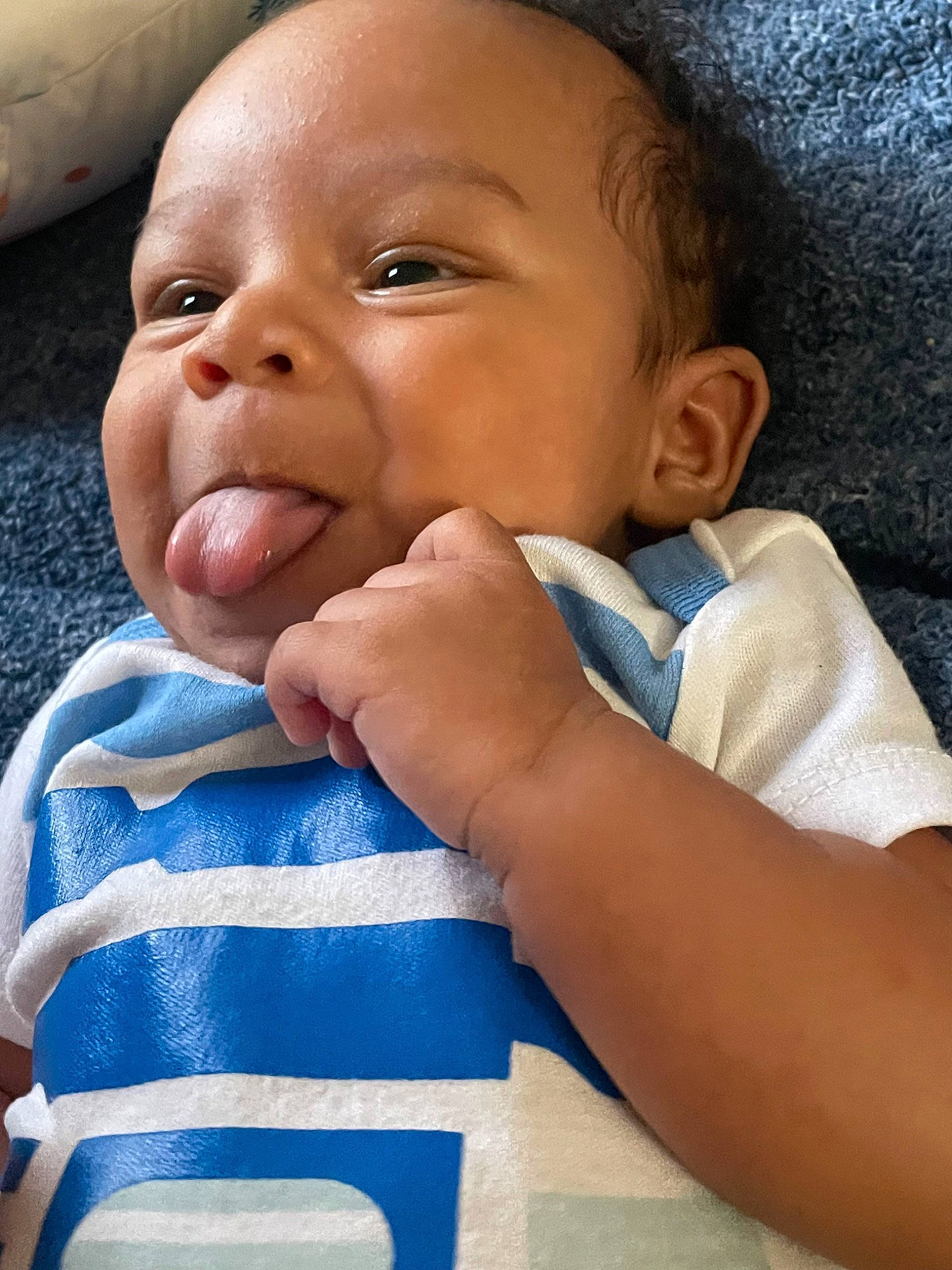 Cassius is registered to the contest to win money with this photo: azure, baby, baby_toddler_clothing, cheek, child, comfort, eyebrow, eyelash, finger, gesture, happy, iris, lip, mouth, nail, nose, person, skin, sleeve, thumb