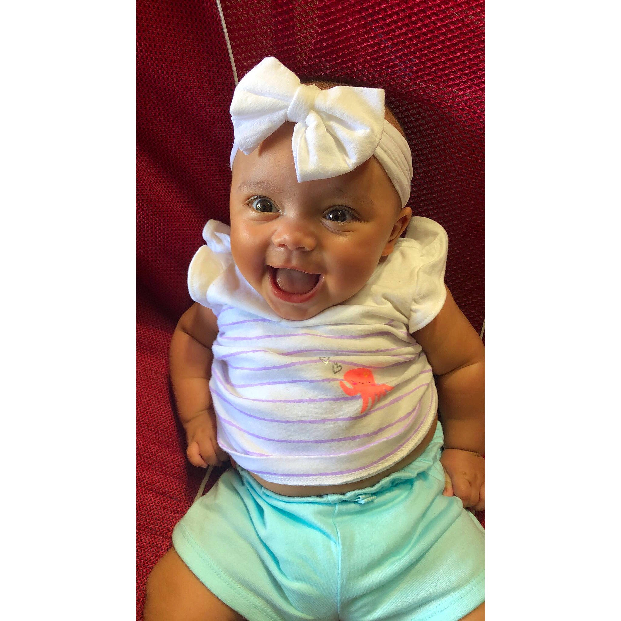 Kayleigh is registered to the contest to win money with this photo: baby, baby_laughing, baby_products, baby_toddler_clothing, bonnet, cheek, child, hand, happy, head, headgear, joy, laugh, person, play, product, smile, t_shirt, toddler