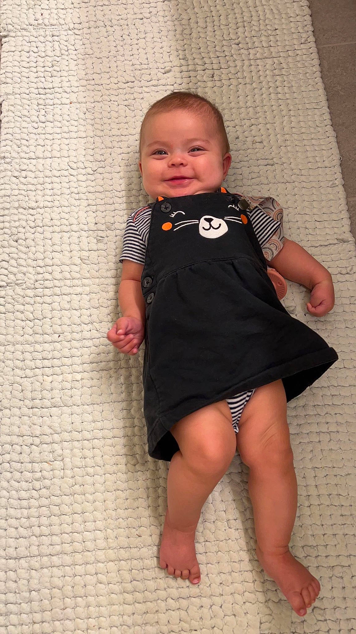 Emilee joined the competition — help win amazing prizes! baby, baby_toddler_clothing, cheek, child, day_dress, face, finger, flooring, happy, human_body, human_leg, joy, neck, one_piece_garment, pattern, person, sitting, skin, sleeve, smile