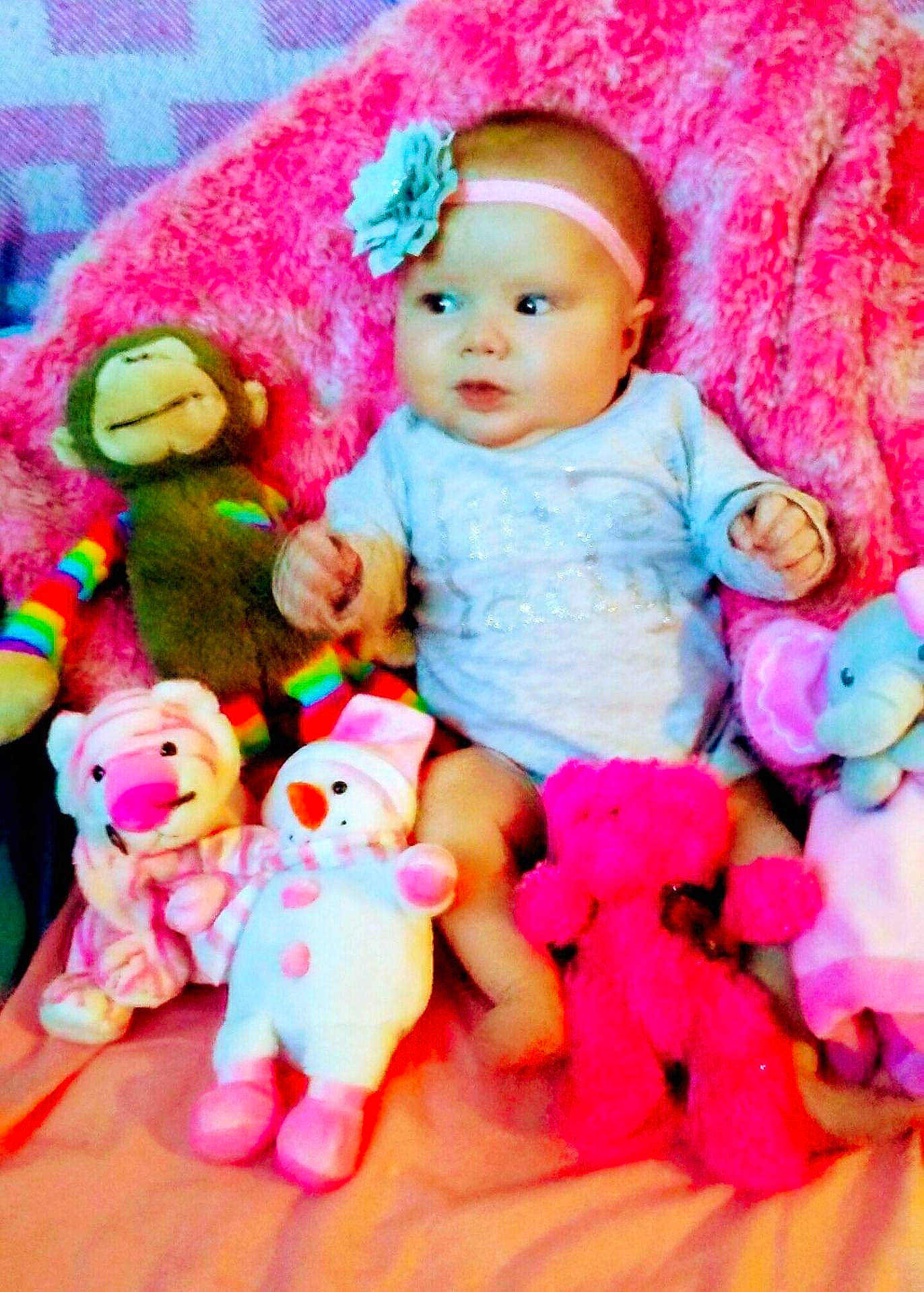 Julianna joined the competition — help win amazing prizes! baby, baby_toddler_clothing, baby_toys, beanie, cheek, child, doll, fashion_accessory, fur, magenta, peach, person, pink, plush, sitting, skin, stuffed_toy, textile, toy, white