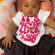Aaliyah is registered to the contest to win money with this photo: baby, child, infant, headband, pink, white_shoes, black_skirt, gold_necklace, shirt, blanket, sitting, indoor, cute, fashion, footwear, person, portrait, accessory, floor, bag