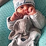 baby, infant, blanket, hat, clothing, face, hand, cushion, quilted, sleepwear, newborn, person, cute, soft, resting, cozy, indoors, portrait, toddler, sleep