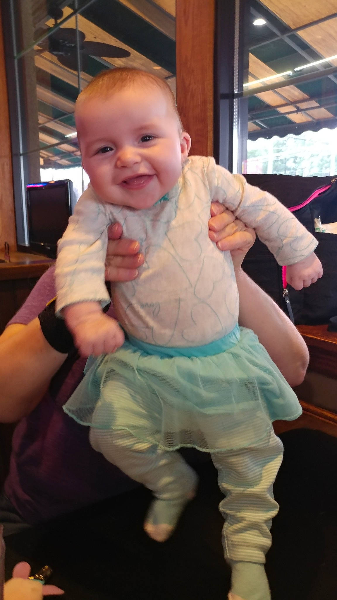 Carley is registered to the contest to win money with this photo: arm, baby, cheek, child, fun, person, sitting, skin, sleeve, smile, toddler